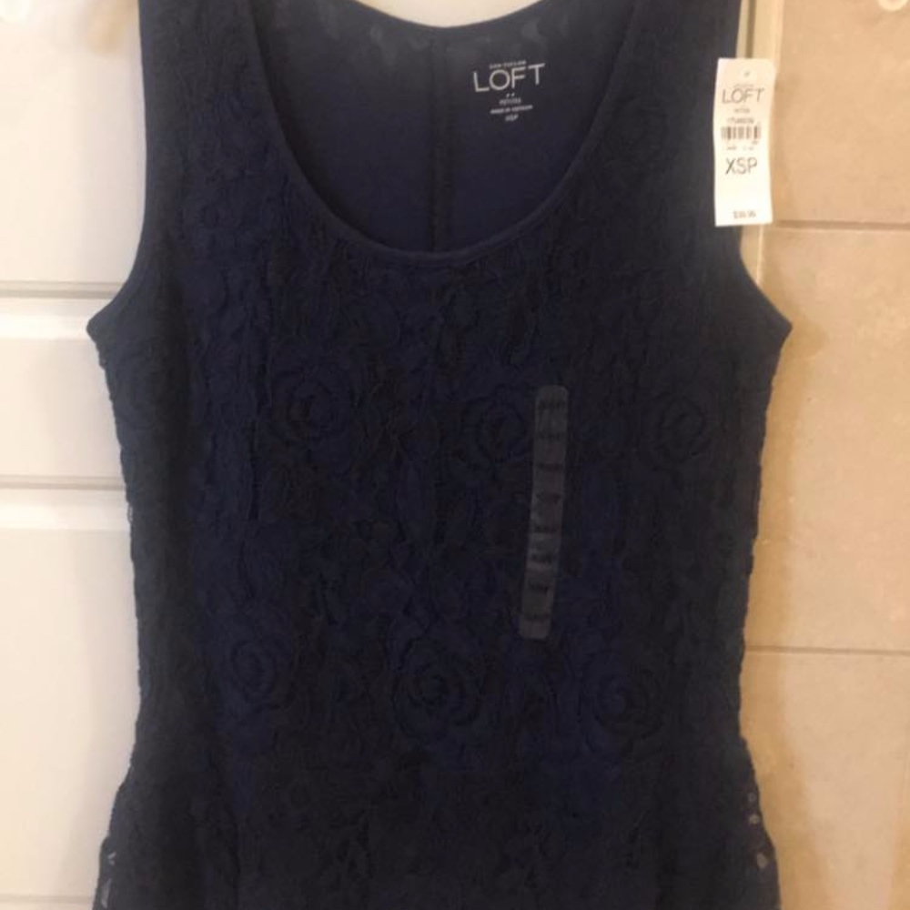NWT. Navy blue sleeveless top with lace detail.